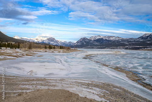 Abraham lake landscape in winter season with wave of snow on bluish ice