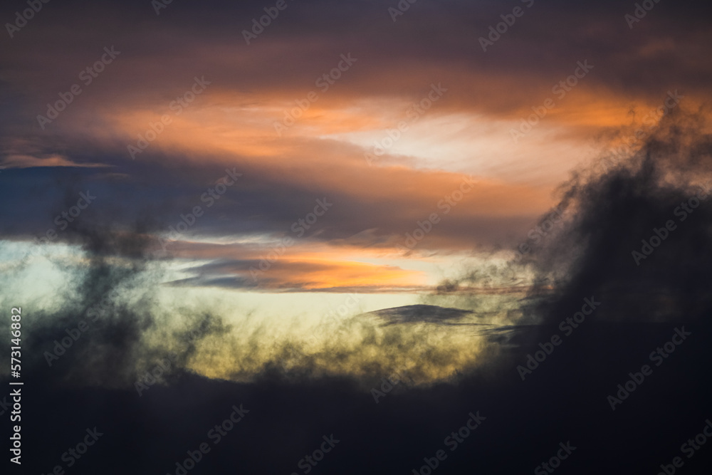 Amazing sunrise sky landscape. Clouds in spectaculare shapes and color during an orange vivid color sunrise view. Great for wallpaper and background image.
