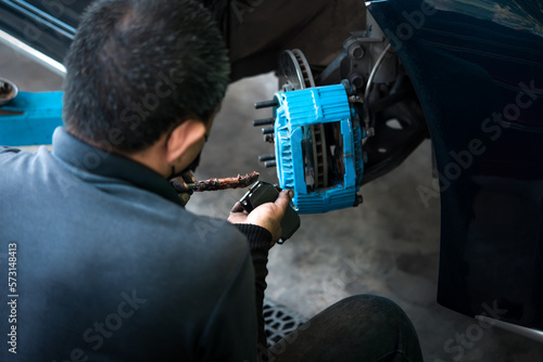 Checking car brake system for repair at car garage