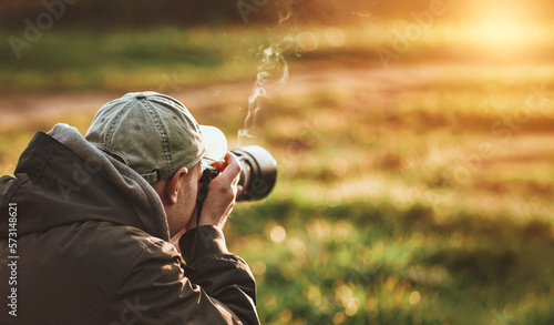 Man taking photo landscape with a big professional camera