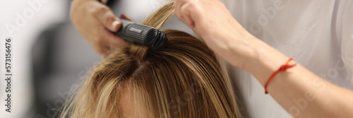 Pulling strands of hair with professional iron care