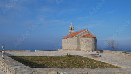 Church against the blue sky. Church in the mountains. Church of Sveti Stefan in Montenegro