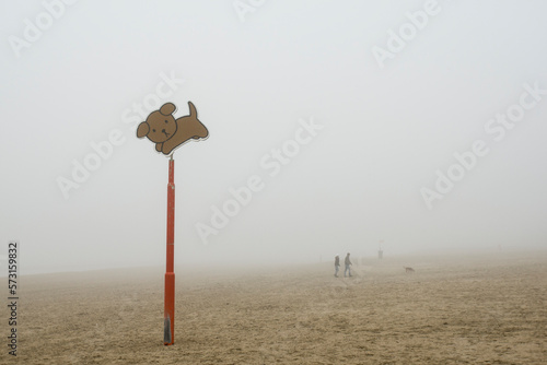 A dog's allowed sign on the beach is seen in the fog on the coast of the Netherlands.