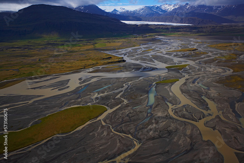 Aerial shot of glacial river emerging from the Myrdalsjokull glacier photo
