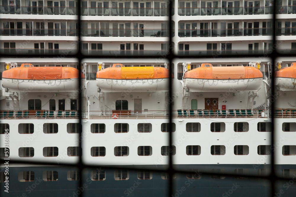 View of cruise ship life rafts through an old window View of cruise ship life rafts through an old window