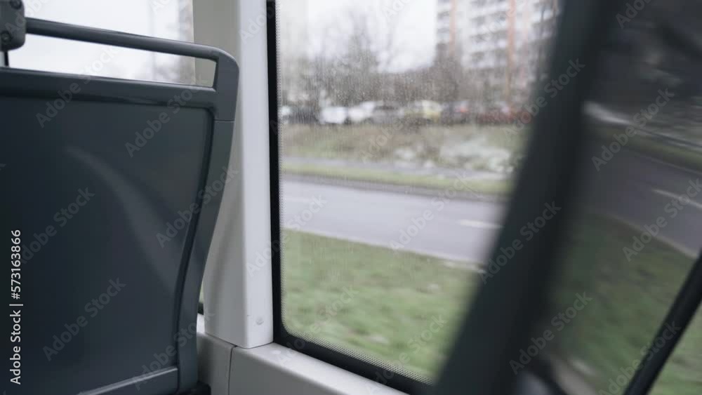 View from the window of public transport on the city road in rainy weather. View from the window of public transport on the city road in rainy weather.