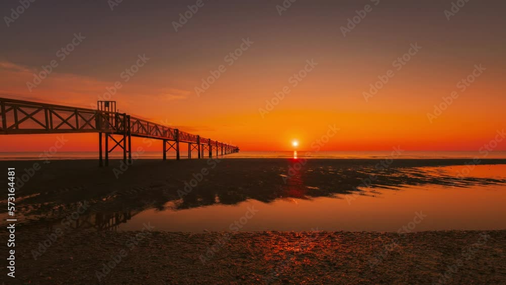Sunrise on the sea with sun movement and pier on the beach, Timelpase 4K Sunrise on the sea with sun movement and pier on the beach, Timelpase 4K