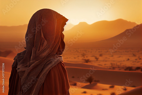 Muslim woman in a veil looks at the sunset over the desert. AI generated.