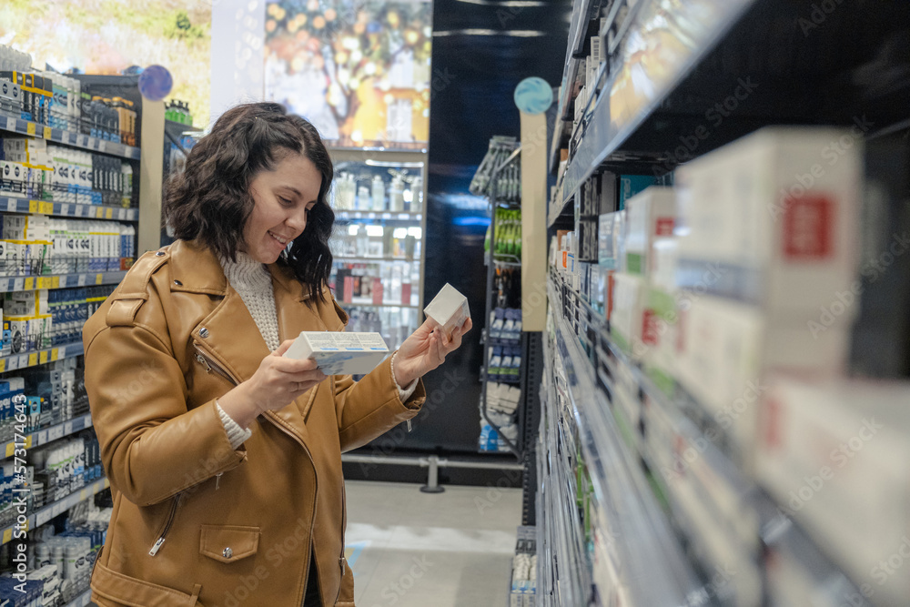 In the store, a woman picks toothpaste