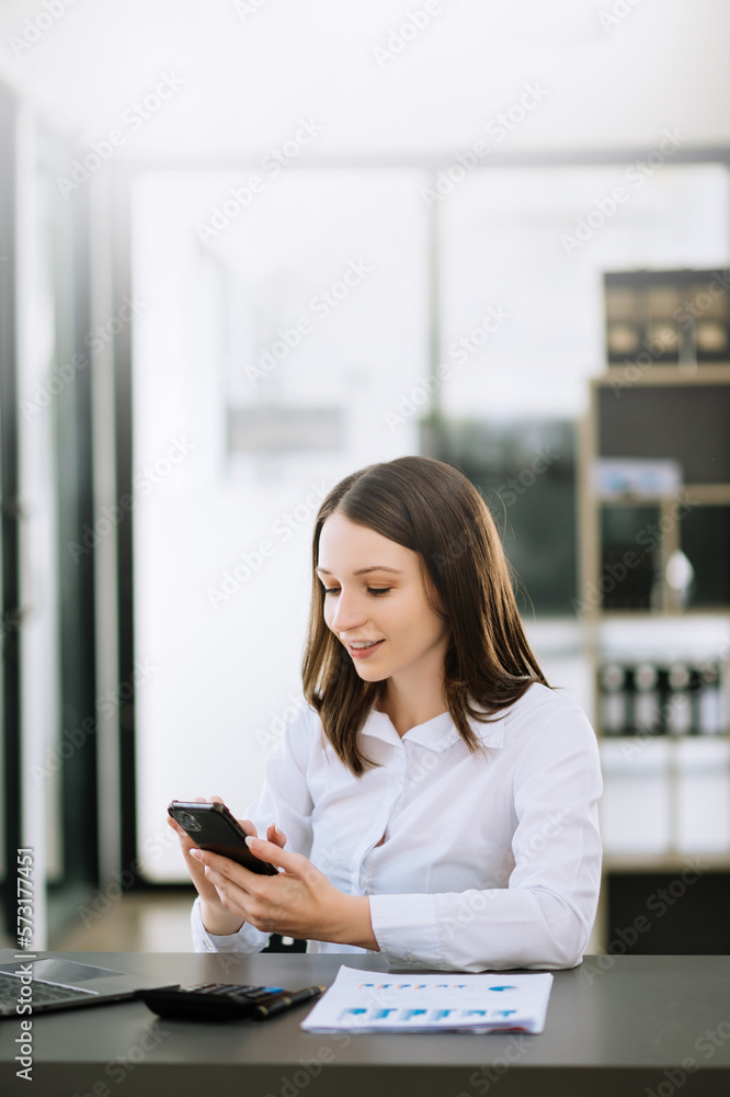 Young attractive Asian woman smiling thinking planning writing in notebook, tablet and laptop working at office Young attractive Asian woman smiling thinking planning writing in notebook, tablet and laptop working at office