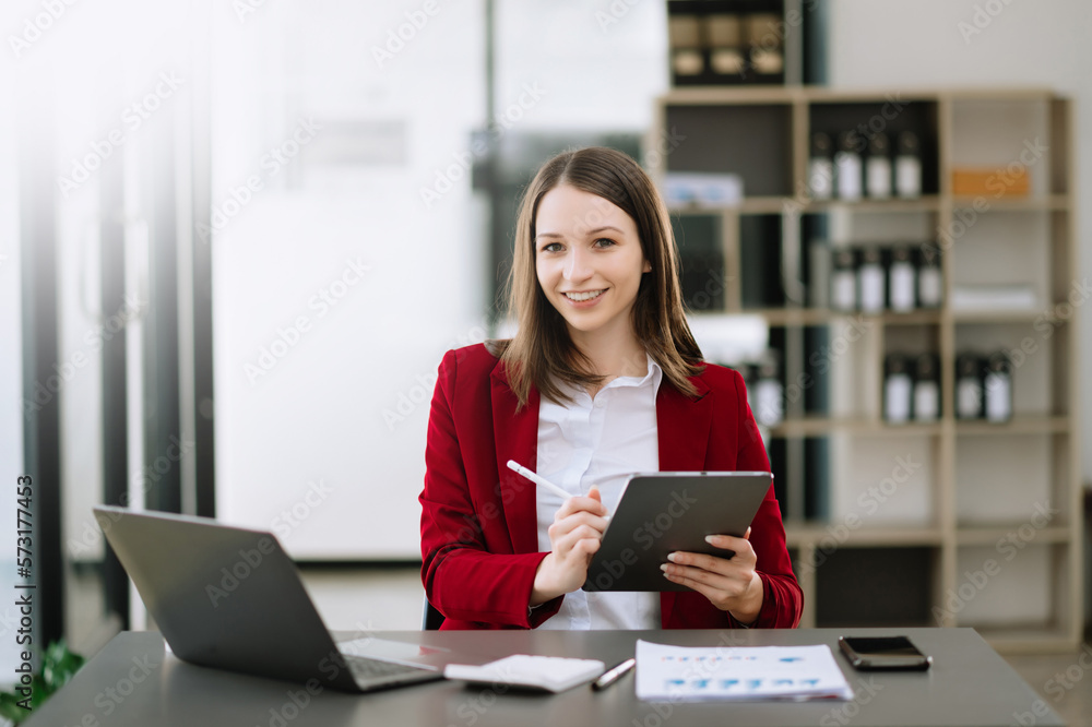 Woman freelancer is working her job on computer tablet and laptop Doing accounting analysis report real estate investment data, Financial at office. Woman freelancer is working her job on computer tablet and laptop Doing accounting analysis report real estate investment data, Financial at office.