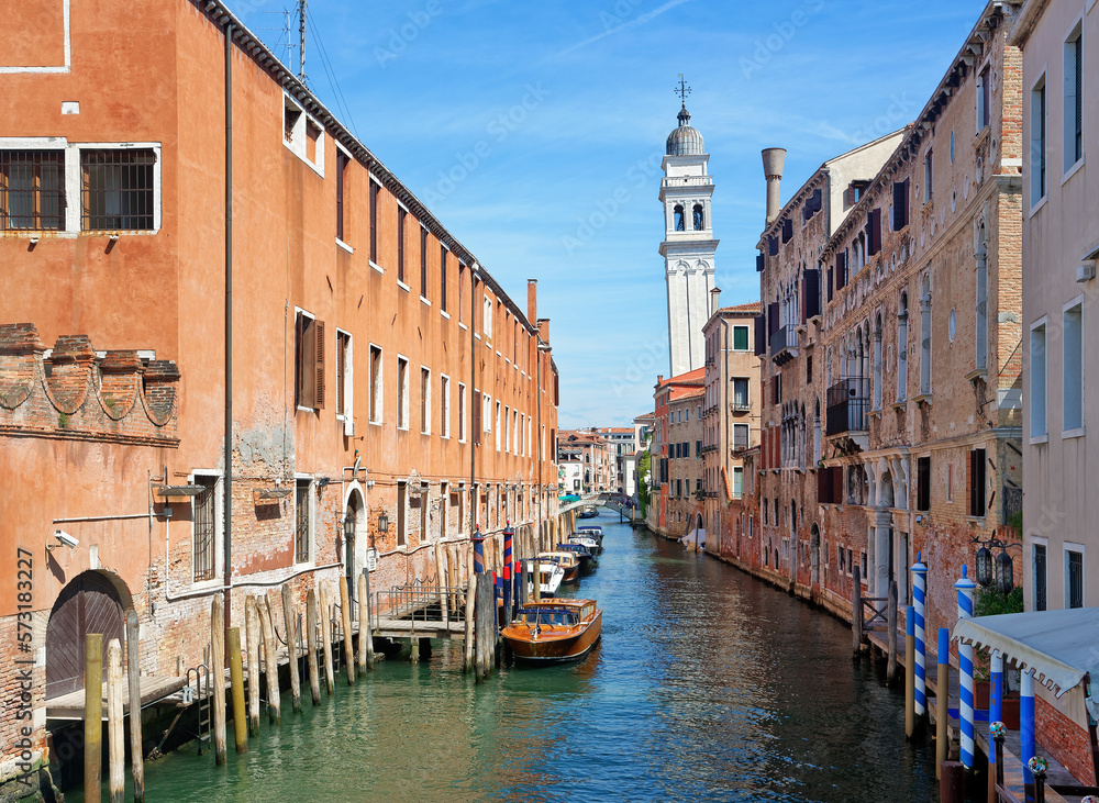 Canal with boats in Venice and Greek orthodox church San Giorgio dei Greci in the background 
