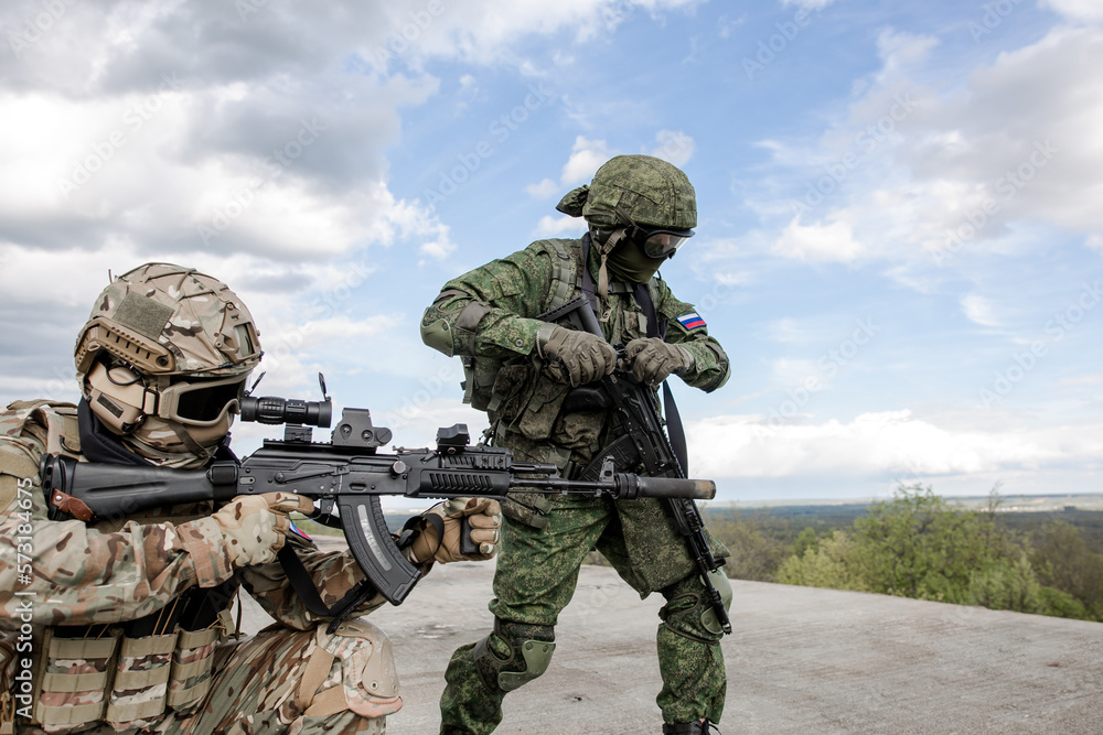 Fototapeta premium Military soldiers shoot opponents in the rooftop war