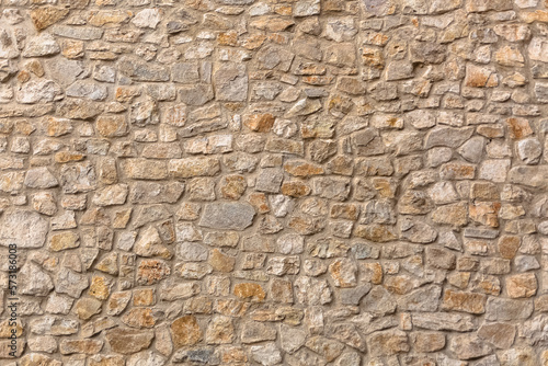 Architecture textures, detailed and rustic of paired masonry granite, traditional spanish and portuguese granite wall, typical iberian orange granite