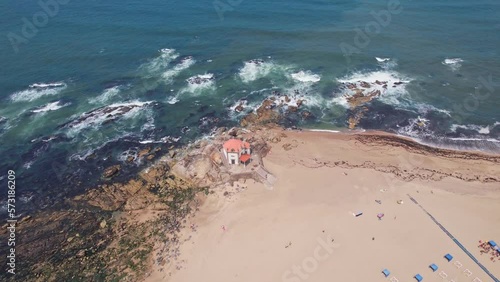 Wallpaper Mural Senhor da Pedra. Cinematic aerial view of Chapel of the Lord of the Stone in Miramar beach near the ocean, a Famous Landmark in Portugal.  Torontodigital.ca