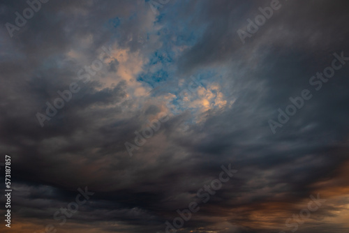 Cloudscape background. Dramatic clouds at sunrise or sunset