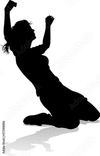 A female soccer football player woman in silhouettes