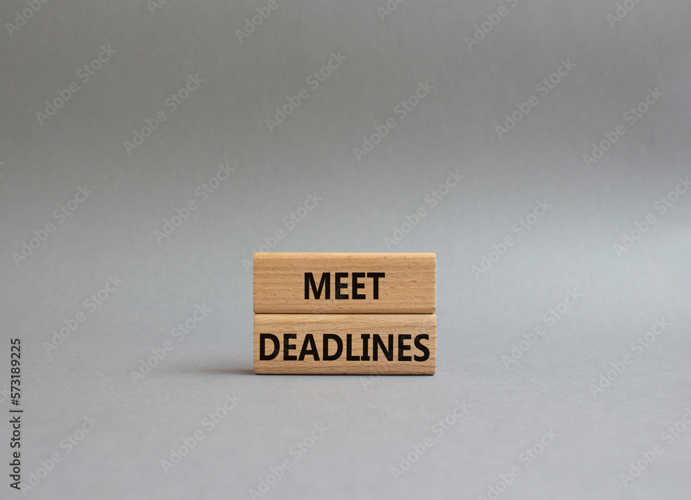 Meet Deadlines symbol. Concept word Meet Deadlines on wooden blocks. Beautiful grey background. Business and Meet Deadlines concept. Copy space Meet Deadlines symbol. Concept word Meet Deadlines on wooden blocks. Beautiful grey background. Business and Meet Deadlines concept. Copy space