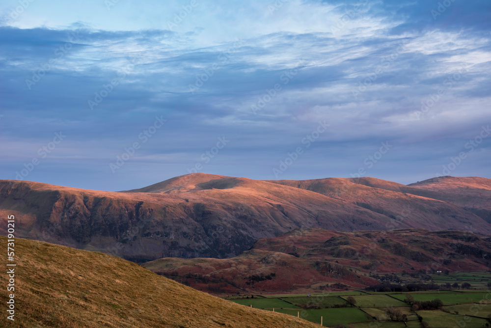 Wonderful vibrant sunset landscape image of view from Latrigg Fell towards Great Dodd and Stybarrow Dodd in Lake District