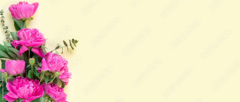 Bouquet of beautiful delicate pink peonies on yellow  paper background. Minimal concept backdrop.