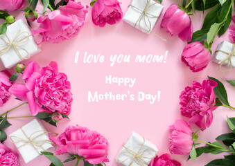 Bouquet of beautiful pink peonies with gift boxes in paper wrapping. Round frame of flowers. Background with text Happy Mother's Day!