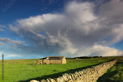 Clouds resembling a hand with a derilict barn in Weardale, County Durham, England, UK. photo