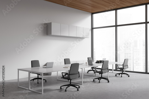 Light business room interior with chairs and shared table, panoramic window
