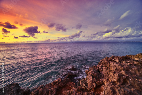 beautiful orange purple sunset on over the ocean on coral rock