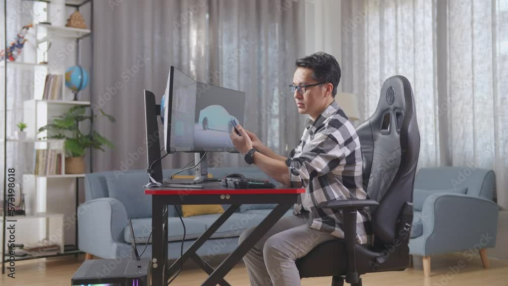 Side View Of Asian Male Automotive Designer Looking At His Smartphone Then Celebrating The Success While Working On 3D Model Of Ev Car On The Desktop Computers At Home
Side View Of Asian Male Automotive Designer Looking At His Smartphone Then Celebrating The Success While Working On 3D Model Of Ev Car On The Desktop Computers At Home