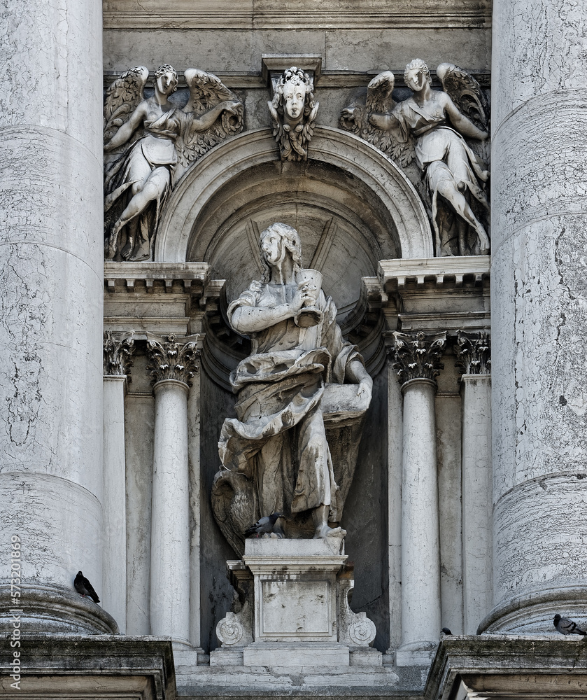 Statues of John on facade of Basilica Di Santa Maria Della Salute Roman Catholic church in Venice, Italy