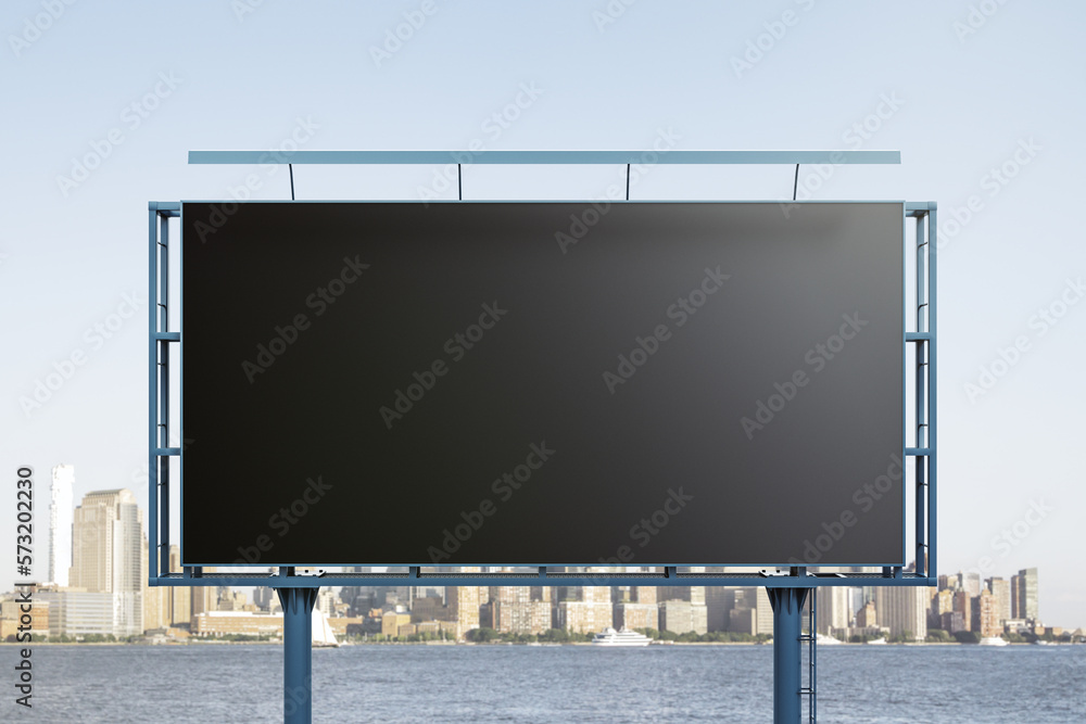 Obraz premium Blank black billboard on cityscape background, front view. Mock up, advertising concept