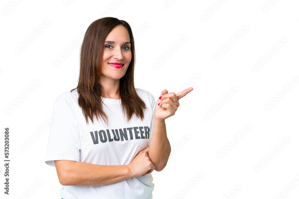Middle age volunteer woman over isolated chroma key background pointing finger to the side Middle age volunteer woman over isolated chroma key background pointing finger to the side