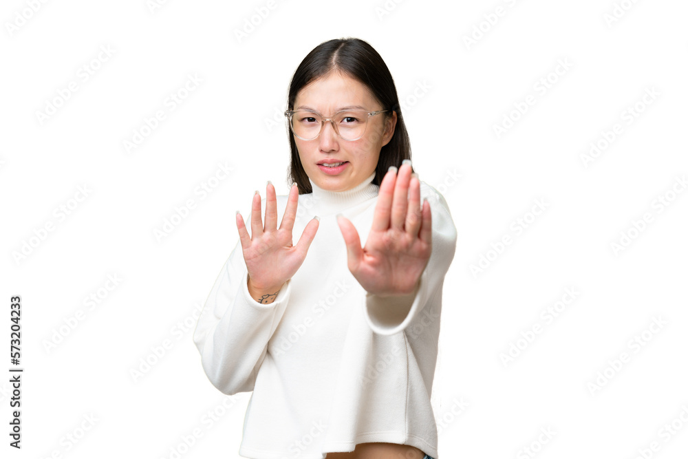 Young Asian woman over isolated background extending hands to the side for inviting to come Young Asian woman over isolated background extending hands to the side for inviting to come