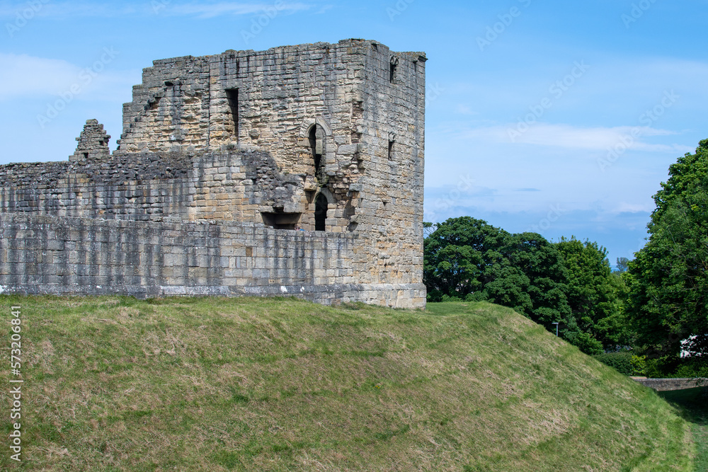 Warkworth Castle ruined exterior walls on mound in Northumberland, UK