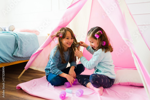 Adorable best friend playing with their hair photo