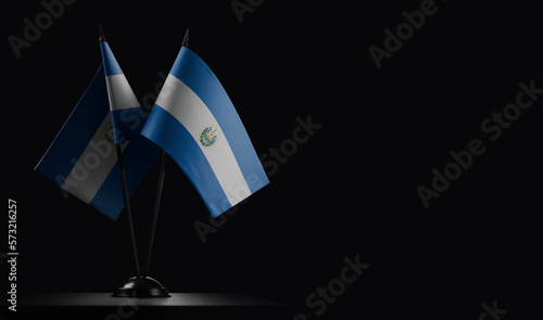 Small national flags of the Salvador on a black background
