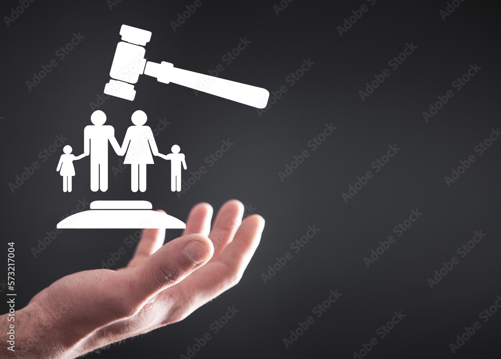 Male hand holding judge gavel with a family symbol. Family Law Male hand holding judge gavel with a family symbol. Family Law
