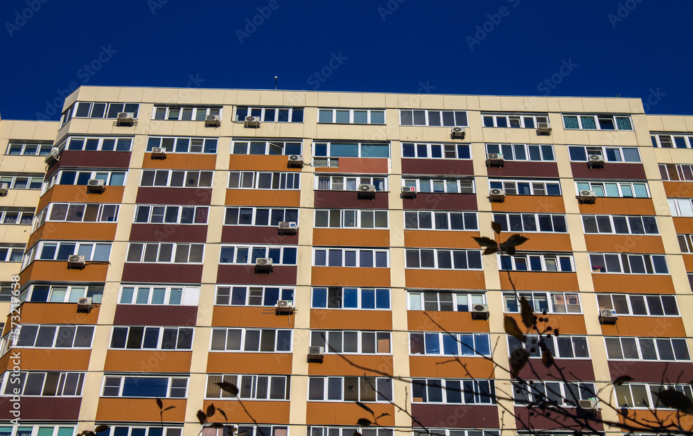 A wall with windows of a modern multi-storey house in a close-up in Reutov near Moscow and a space for copying on a sunny day