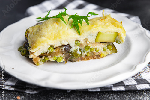 vegetable casserole eggplant, zucchini, green peas, cheese, bechamel sauce vegetables lasagne meal food snack on the table copy space food background rustic top view