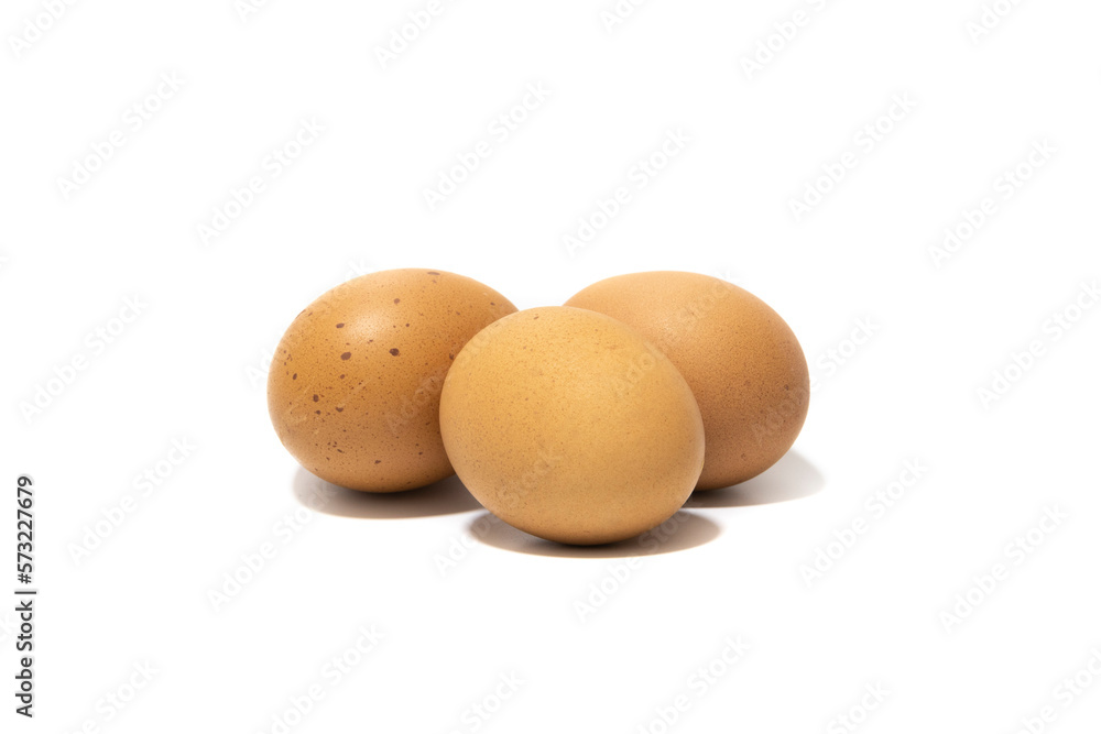Three brown chicken eggs. Isolated on a white background. Vegetarian food concept. Three brown chicken eggs. Isolated on a white background. Vegetarian food concept.