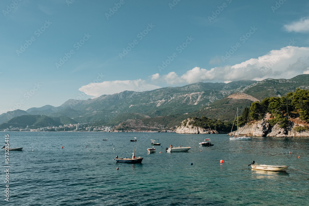 Budva coastline with boats and mountains in the backdrop from Sveti Stefan island, Montenegro