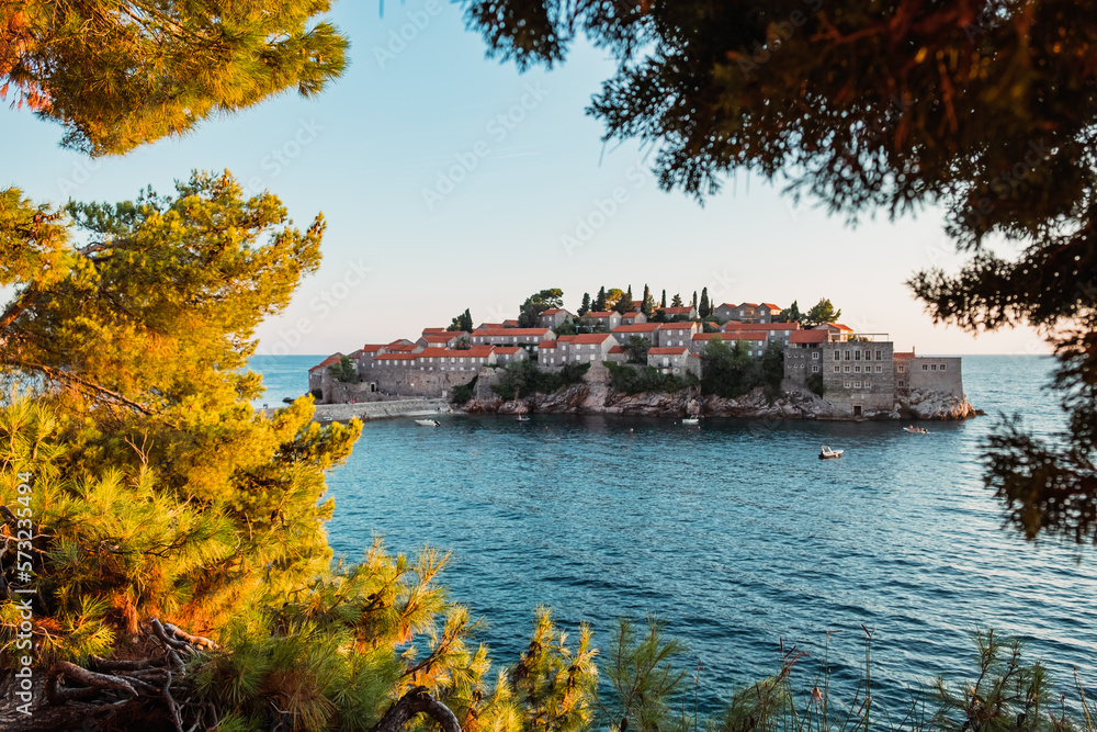 Fototapeta premium Sveti Stefan island in Budva, Montenegro at sunset, clear sky, no people