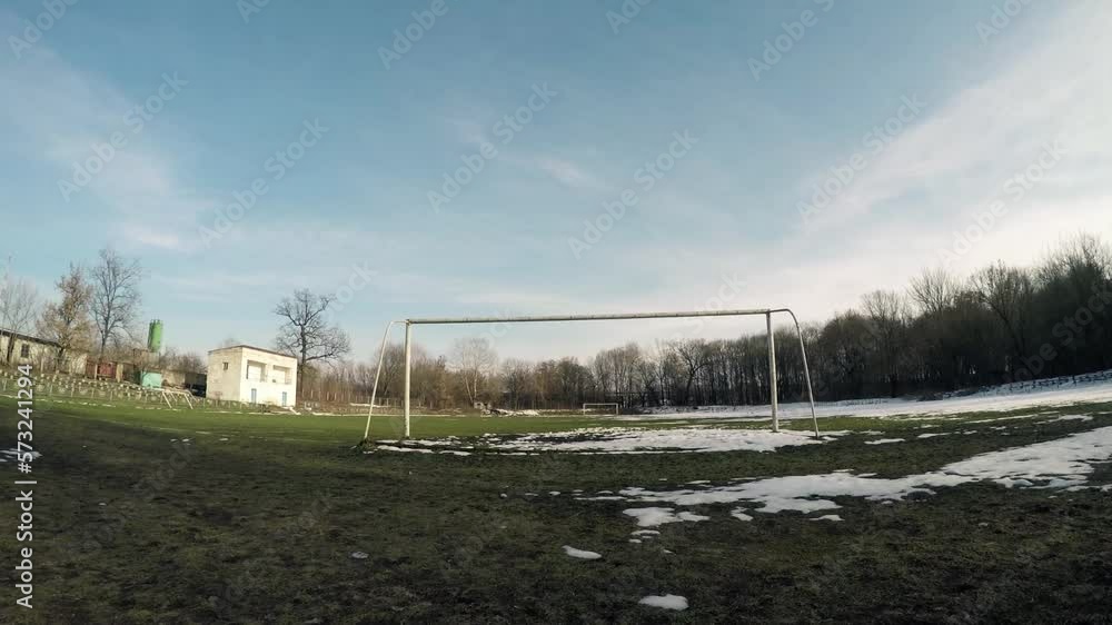 Empty football goal on a deserted snow-covered football field in winter. Empty football goal on a deserted snow-covered football field in winter.