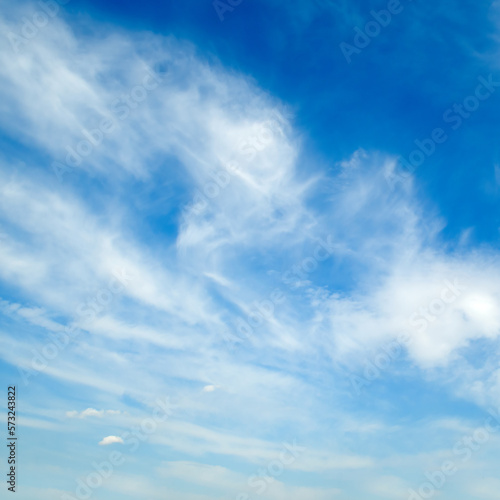 Blue sky with light feathery clouds.