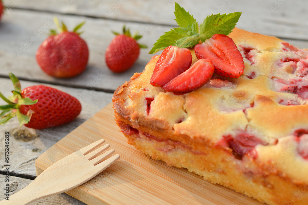 Delicious summer dessert strawberry pie, sweet homemade holiday cake decorated with mint leaves on a light wooden table. Delicious summer dessert strawberry pie, sweet homemade holiday cake decorated with mint leaves on a light wooden table.