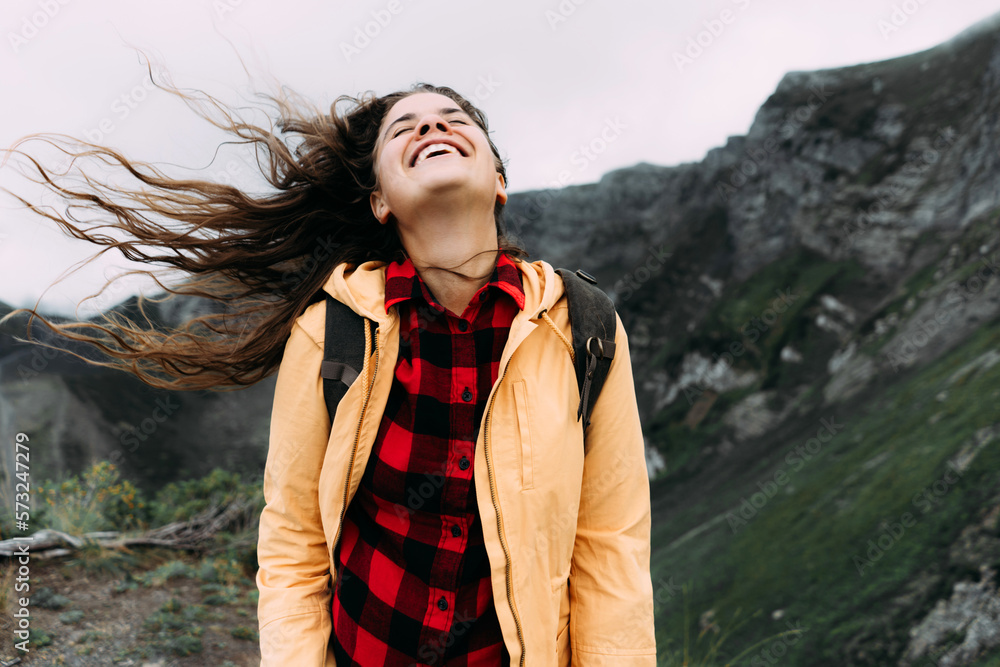 Young happy laughing carefree woman with hair blowing in the wind. Young happy laughing carefree woman with hair blowing in the wind.