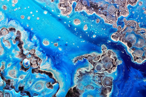 Luxury abstract background  liquid art. Blue alcohol ink with golden paint streaks  water surface  marble texture