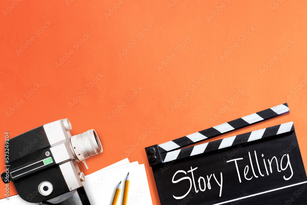 Naklejka premium Story telling. text title on film slate or clapperboard and the old 8mm movie film camera for filmmaker and film industry.