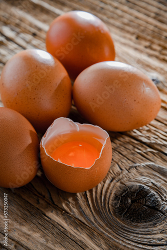 Composition with five chicken eggs on a wooden table