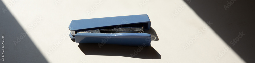 Close up of blue stapler on the table Close up of blue stapler on the table
